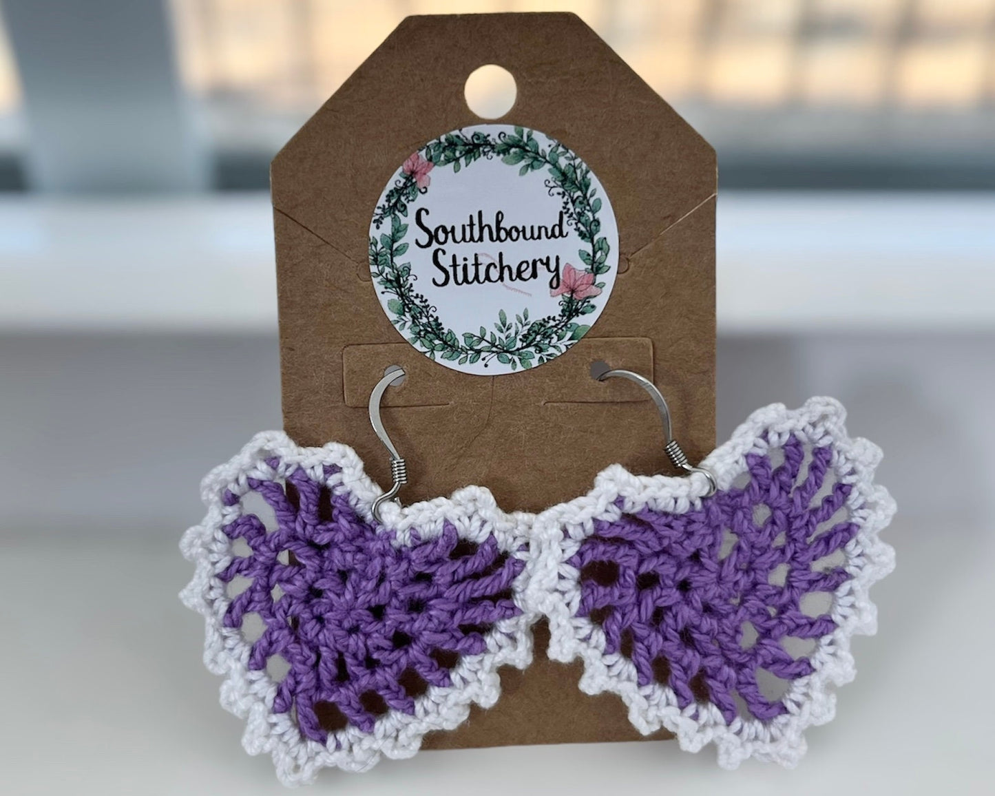 Crocheted heart earrings on a Southbound Stitchery branded card.
