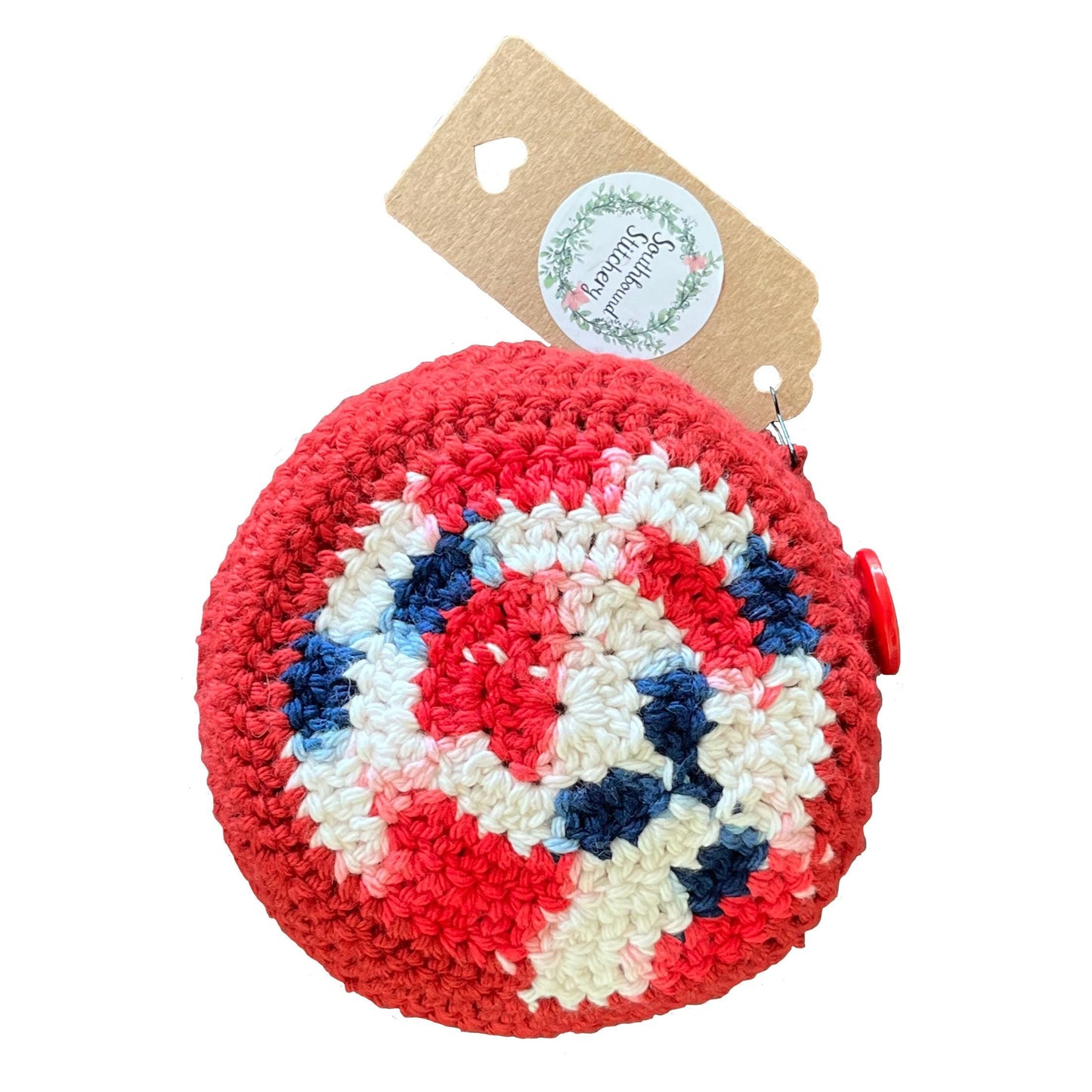 Red, white, and blue crocheted bag folded up on a white background