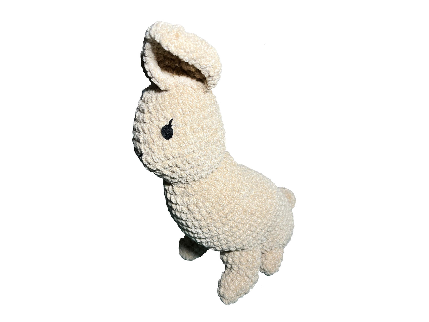 Plush crocheted toy resembling a bunny on a white background