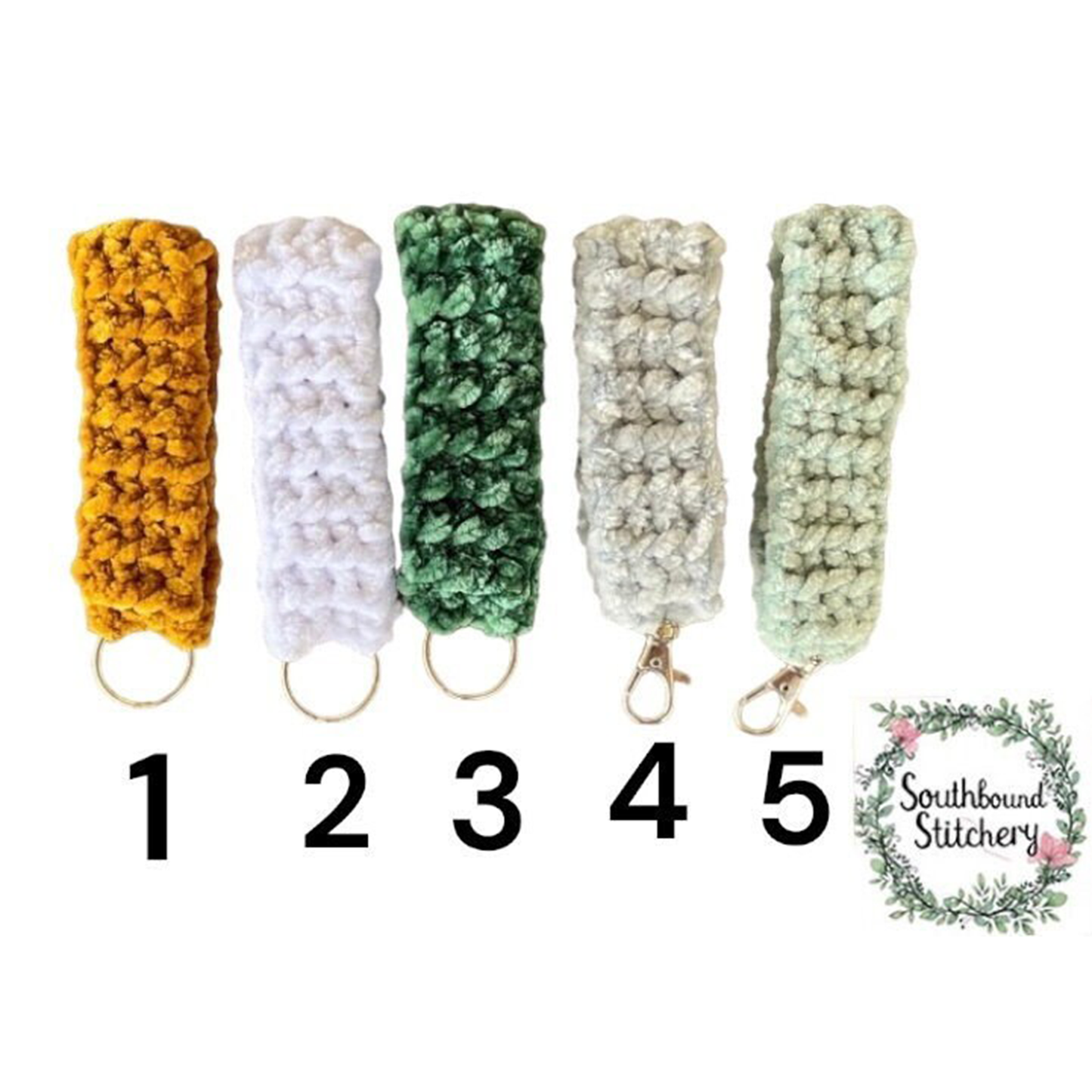 Five crocheted keychains in different colors with numbers and a brand logo on a white background.