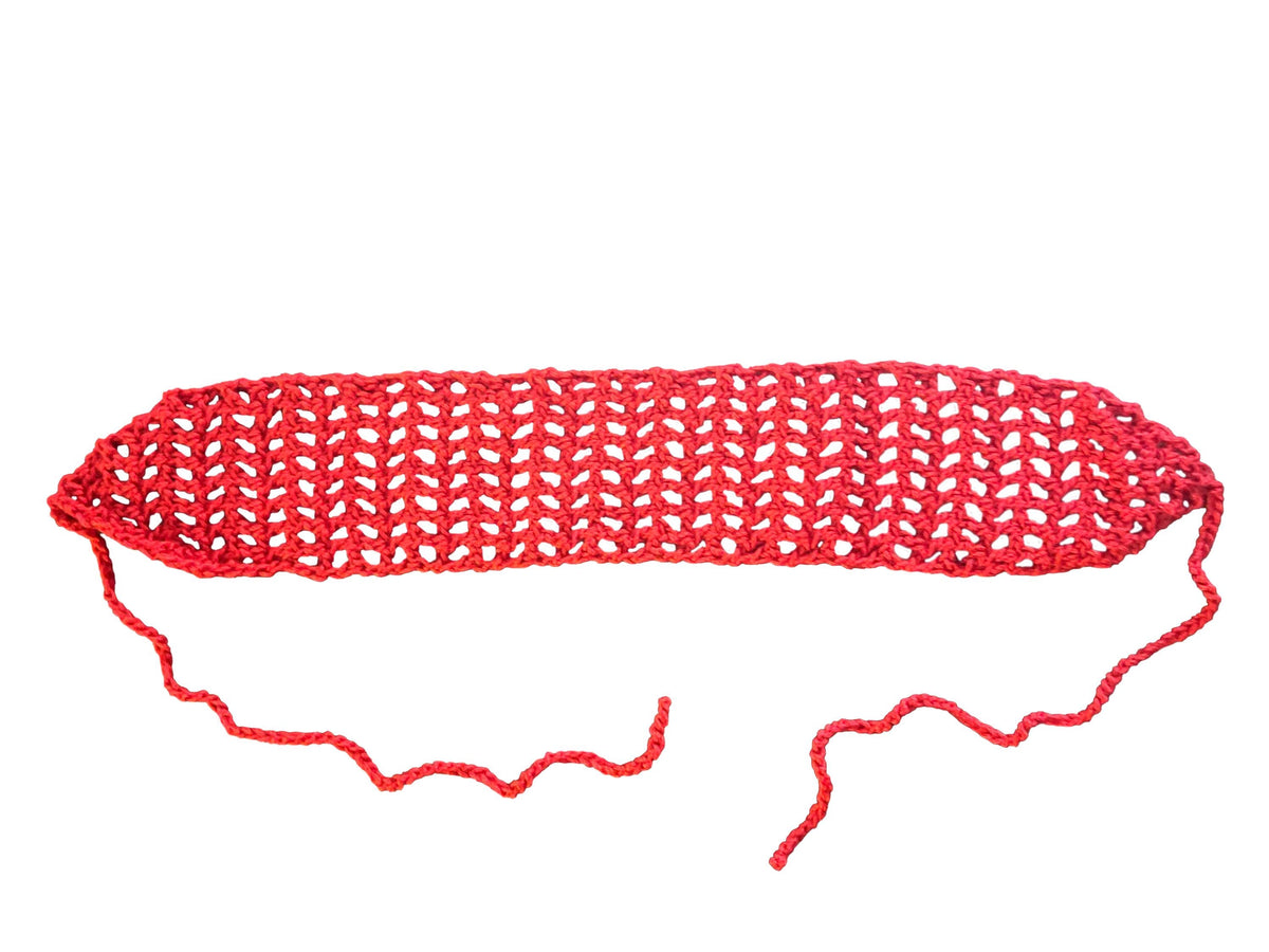 Red crocheted headband on a white background
