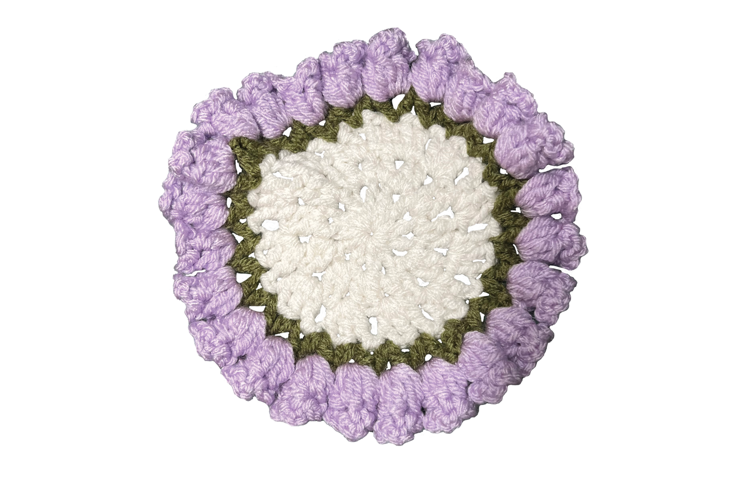 Round crochet coaster with purple outer rim and white center on a white background